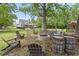 Spacious backyard with fire pit area, seating, and mature trees, perfect for outdoor entertaining at 856 W Highway 9, Longs, SC 29568