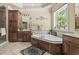 Large bathroom with a soaking tub, built-in storage and vanity with a large mirror at 856 W Highway 9, Longs, SC 29568