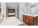 Bathroom featuring a large vanity, walk-in shower, and wooden storage shelves at 856 W Highway 9, Longs, SC 29568