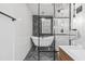Modern bathroom featuring a soaking tub with black herringbone tile accent and glass shower enclosure at 856 W Highway 9, Longs, SC 29568
