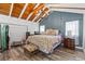 Cozy bedroom with vaulted wood ceilings, decorative chandelier, and comfortable furnishings at 856 W Highway 9, Longs, SC 29568
