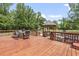 Stained wooden deck with outdoor dining set, pergola, and backyard views at 856 W Highway 9, Longs, SC 29568