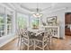 Sunlit dining room featuring a decorative chandelier, tray ceilings, and multiple windows overlooking the yard at 856 W Highway 9, Longs, SC 29568