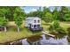 Exterior of waterfront cottage featuring a dock, private yard, and lake views at 856 W Highway 9, Longs, SC 29568