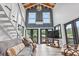 Living room with vaulted ceilings, hardwood floors, staircase and water view at 856 W Highway 9, Longs, SC 29568