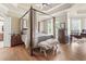 Spacious main bedroom features a four poster bed, hardwood floors, and tray ceilings at 856 W Highway 9, Longs, SC 29568