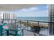 Oceanfront balcony with seating offers stunning views of the beach, ocean, and neighboring hotels at 8560 Queensway Blvd. # 1109, Myrtle Beach, SC 29572