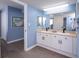 Double sink bathroom vanity with light wood floors and cool blue walls, offering style and function at 8560 Queensway Blvd. # 1109, Myrtle Beach, SC 29572