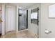 This is a cozy bathroom with stone floors, a glass-enclosed shower, and a modern towel warmer at 8560 Queensway Blvd. # 1109, Myrtle Beach, SC 29572