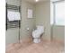 Well-lit bathroom with a modern toilet, tiled floors, and a towel warmer at 8560 Queensway Blvd. # 1109, Myrtle Beach, SC 29572