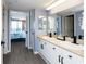 En-suite bath with dual sinks, modern faucets, and access to a bedroom with balcony access at 8560 Queensway Blvd. # 1109, Myrtle Beach, SC 29572