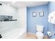 Clean and tidy bathroom featuring tile shower, modern toilet, and light blue walls at 8560 Queensway Blvd. # 1109, Myrtle Beach, SC 29572