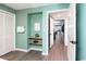 Bathroom features a neutral paint color, wood flooring, an adjacent storage area, and hallway access at 8560 Queensway Blvd. # 1109, Myrtle Beach, SC 29572