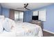 Bedroom with two beds, blue walls, ceiling fan, dresser, and a sliding glass door to balcony at 8560 Queensway Blvd. # 1109, Myrtle Beach, SC 29572