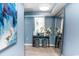 Bright foyer area with blue walls, decorative table, mirror, and stools provides a welcoming entrance at 8560 Queensway Blvd. # 1109, Myrtle Beach, SC 29572