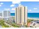 Oceanfront high-rise condo building with palm trees, parking, and beach access on a bright, sunny day at 8560 Queensway Blvd. # 1109, Myrtle Beach, SC 29572