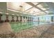 A bright, spacious indoor pool with seating, ideal for year-round enjoyment and exercise at 8560 Queensway Blvd. # 1109, Myrtle Beach, SC 29572