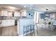 Open-concept kitchen and dining room with stainless steel appliances, bar seating, and modern light fixtures at 8560 Queensway Blvd. # 1109, Myrtle Beach, SC 29572