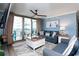 Living room with sliding glass door to a balcony, plush seating, and coastal decor at 8560 Queensway Blvd. # 1109, Myrtle Beach, SC 29572