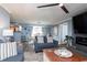 Comfortable living room boasts an open layout with a dining area and modern fireplace beneath a flat screen tv at 8560 Queensway Blvd. # 1109, Myrtle Beach, SC 29572