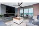 Cozy living room featuring a fireplace, flat-screen TV, and sliding glass doors to the balcony with ocean views at 8560 Queensway Blvd. # 1109, Myrtle Beach, SC 29572