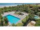 A swimming pool and sun lounging area overlook a sandy beach and an ocean pier in the distance at 8560 Queensway Blvd. # 1109, Myrtle Beach, SC 29572