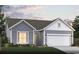 Charming single-story home with a two-car garage, manicured lawn, and inviting curb appeal at 8635 Farrier Dr., Myrtle Beach, SC 29588