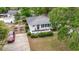 Aerial view showcasing the home, well-manicured yard, driveway, and surrounding lush trees at 908 Wood St., North Myrtle Beach, SC 29582