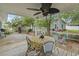 Cozy back deck with a ceiling fan, round table, and seating, perfect for outdoor dining and relaxation with an inviting hammock at 908 Wood St., North Myrtle Beach, SC 29582