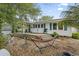 Backyard featuring a hammock, wooden deck, and gravel area, creating a relaxing outdoor space at 908 Wood St., North Myrtle Beach, SC 29582
