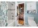 Stylish bathroom featuring tiled shower and tub, with a glimpse into a cozy bedroom at 908 Wood St., North Myrtle Beach, SC 29582