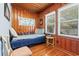 Quaint bedroom with wood paneling, natural light streaming through the window, and cozy furniture at 908 Wood St., North Myrtle Beach, SC 29582