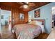 Charming bedroom featuring wood paneling, stylish decor, and an open doorway to other rooms at 908 Wood St., North Myrtle Beach, SC 29582