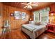Inviting bedroom with wood accents, a ceiling fan, and bright, sunny exposure through multiple windows at 908 Wood St., North Myrtle Beach, SC 29582