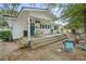 Charming home exterior with a cozy porch, seating, grill, and inviting backyard setup at 908 Wood St., North Myrtle Beach, SC 29582