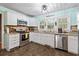 Open kitchen with granite countertops, stainless steel appliances, and ample cabinet space at 908 Wood St., North Myrtle Beach, SC 29582