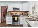 Modern kitchen features stainless steel appliances, granite countertops and white cabinets at 908 Wood St., North Myrtle Beach, SC 29582