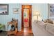 Bright living room showing doorway into the adjacent bathroom, with a wood-framed doorway and stylish decor at 908 Wood St., North Myrtle Beach, SC 29582