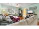 Cozy living room with lots of windows, comfortable seating, and stylish decor, next to a yellow hallway at 908 Wood St., North Myrtle Beach, SC 29582