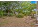 A spacious backyard featuring a shed, lush greenery, flower beds, and meticulous landscaping at 930 S Marlin Circle, Murrells Inlet, SC 29576