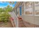 Exterior side view of the home with a brick foundation, white railing, and blue shutters at 930 S Marlin Circle, Murrells Inlet, SC 29576