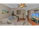 Bright living room with hardwood floors, a sectional, a beach painting, and views to other rooms at 930 S Marlin Circle, Murrells Inlet, SC 29576