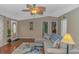 A cozy living room with hard wood floors, sectional sofa, ceiling fan, and neutral walls at 930 S Marlin Circle, Murrells Inlet, SC 29576
