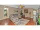 Cozy living room with hardwood floors, a large sectional, ceiling fan and view of kitchen at 930 S Marlin Circle, Murrells Inlet, SC 29576
