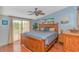 Comfortable bedroom featuring a ceiling fan, wood floors, and access to an outdoor balcony at 930 S Marlin Circle, Murrells Inlet, SC 29576
