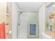 Shower with sliding glass door, seashell decorations, and towel rack in bathroom at 930 S Marlin Circle, Murrells Inlet, SC 29576