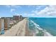 Stunning aerial view showcasing a long beach, clear blue ocean, and towering beachfront properties at 9501 Shore Dr. # A-211, Myrtle Beach, SC 29572