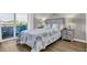 Bright bedroom with access to balcony, features a comfortable queen bed and beach-themed decor at 9501 Shore Dr. # A-211, Myrtle Beach, SC 29572