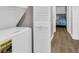 Convenient laundry area with modern washer and dryer units, plus a view of a charming bedroom at 9501 Shore Dr. # A-211, Myrtle Beach, SC 29572