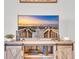 Close-up view of a modern entertainment center displaying a serene beach scene on the television screen at 9501 Shore Dr. # A-211, Myrtle Beach, SC 29572
